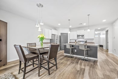 Dining space with light hardwood / wood-style floo