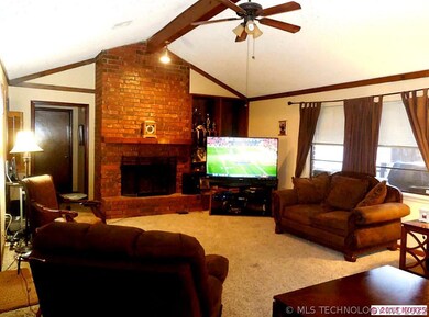 Large living room with vaulted beamed ceiling.  On
