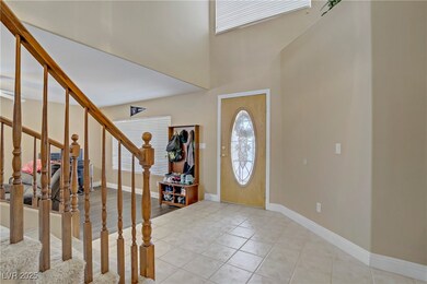 Foyer featuring stairway, a high ceiling, baseboar