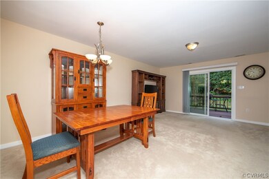 Dining room with chandelier is open to the living