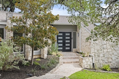 Entrance to property with roof with shingles and 