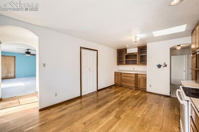 Kitchen featuring arched walkways, white electric 
