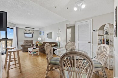 Dining room featuring light wood-style flooring and a textured ceiling