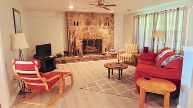 Living Room has this inviting stone fireplace and three large windows to let in loads of light.