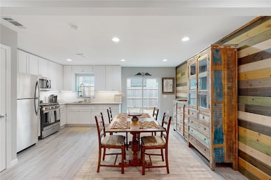 Dining space with light wood-style tile flooring a