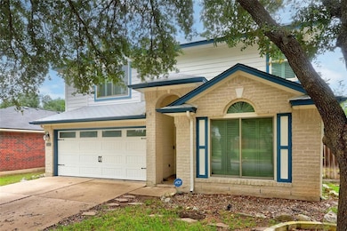 View of front of property with a garage, brick si