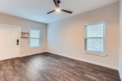Unfurnished room featuring ceiling fan and dark w