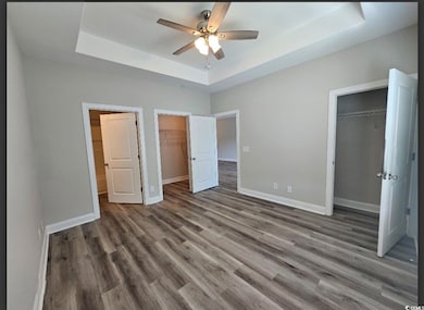 Unfurnished bedroom featuring a closet, a walk in 