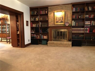 A traditional brick fireplace with mantle is a stu