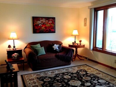 Spacious living room, neutral walls with crown mol