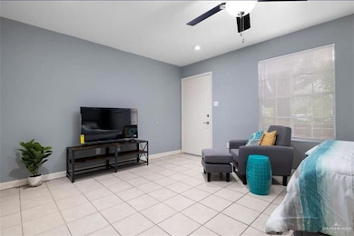 Living area featuring a ceiling fan, light tile patterned floors, and recessed lighting