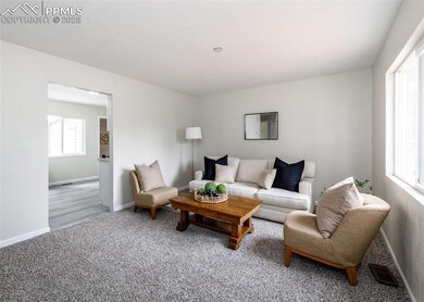 Living room with carpet and baseboards