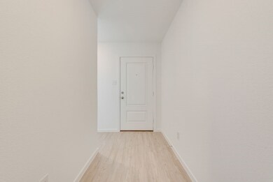 Hall featuring baseboards and light wood-style floors