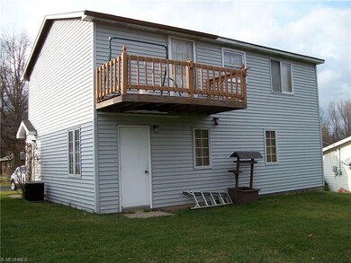 Back deck and man door of Garage with apartment.