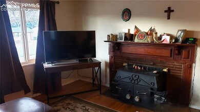 The nice-sized living room has a charming brick fi