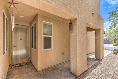 Property entrance featuring stucco siding and a pa