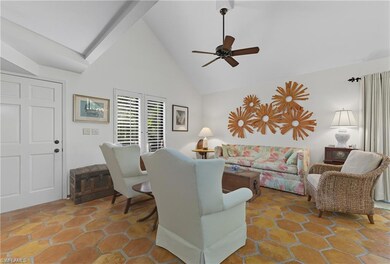 Living area with high vaulted ceiling and a ceiling fan