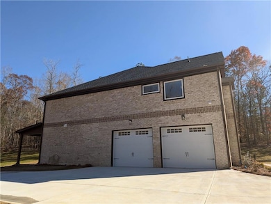 View of side of property featuring a garage, brick