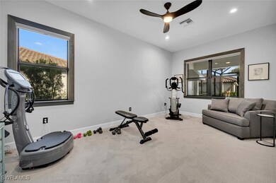 Exercise room with carpet and ceiling fan