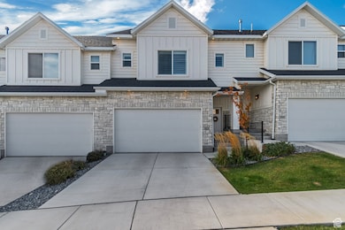 Craftsman-style house with board and batten siding, stone siding, concrete driveway, and an attached garage