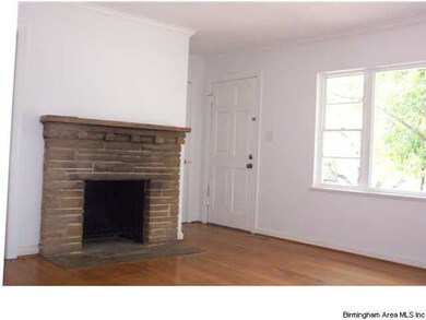 Living room with hardwoods and handsome fireplace,