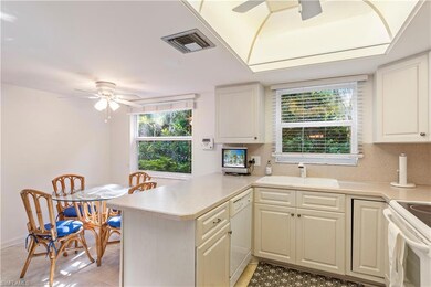 Kitchen featuring a ceiling fan, white appliances, a peninsula, and light countertops