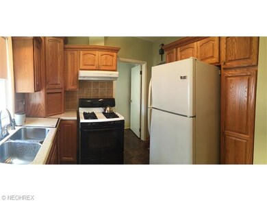 Beautiful Oak Kitchen with Corrian counter tops, gas stove and refrigerator.