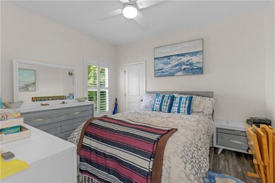 Bedroom with wood finished floors and ceiling fan