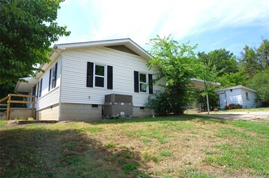 Side of house, ac unit, carport, shed