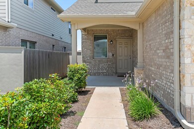 Doorway to property with brick siding and a shing
