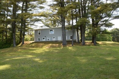 Back of home with yard