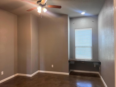 Empty room featuring concrete floors and ceiling 