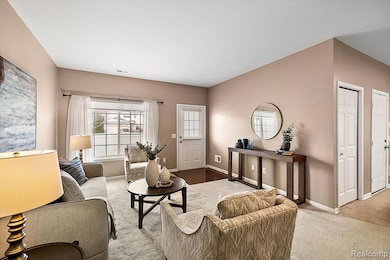 Carpeted living room featuring baseboards