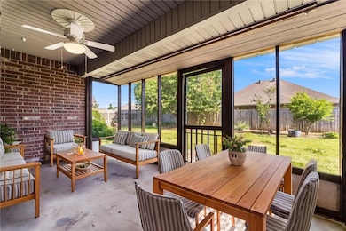 Screened in patio leads to large backyard.
