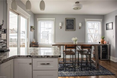 The wood floors continue uninterrupted throughout the large dining space and the updated kitchen.