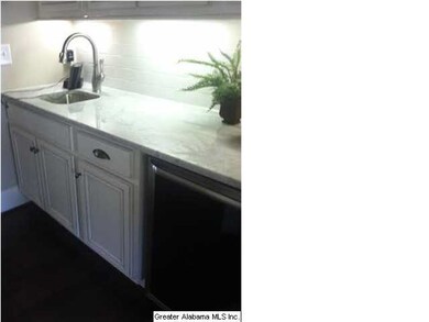 Wet bar by dining room with wine fridge and sink