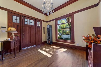 Notice the original floor to ceiling leaded glass 