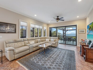 Living room featuring ceiling fan and ornamental m