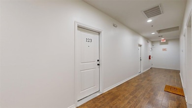 Corridor featuring dark wood finished floors and recessed lighting