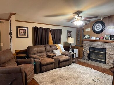 Keeping room featuring a stone fireplace, ceiling 