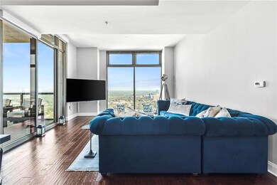Living room featuring wood finished floors, basebo