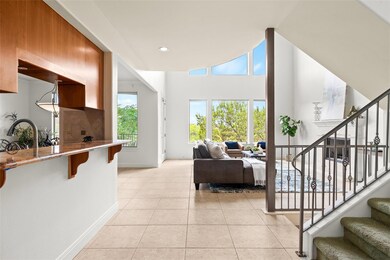 Living room featuring stairs, baseboards, light t