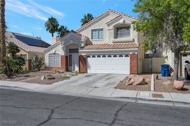 Mediterranean / spanish house with driveway, a tiled roof, a garage, stucco siding, and a chimney