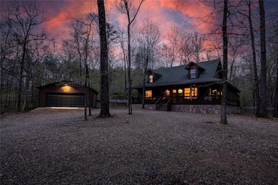 View of front facade featuring a garage, covered p