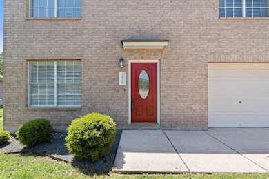 View of exterior entry featuring brick siding and