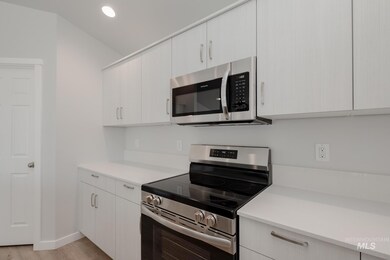 Kitchen with stainless steel appliances, recessed lighting, light wood-style floors, and modern cabinets
