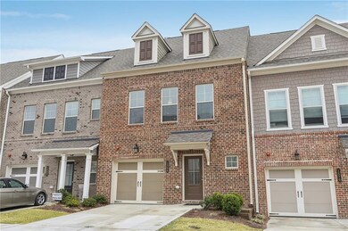 Townhome property featuring driveway, a shingled r