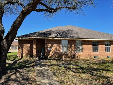 View of front of house featuring brick siding, a f