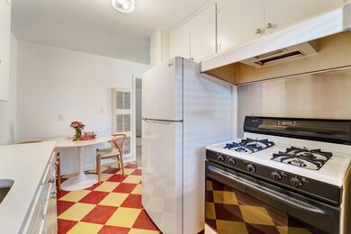 Kitchen with gas range, freestanding refrigerator