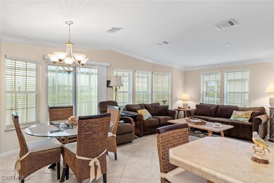 Living room with lofted ceiling, a chandelier, lig